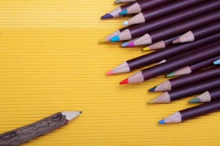 Colored pencils on yellow cardboard backgroundの写真素材