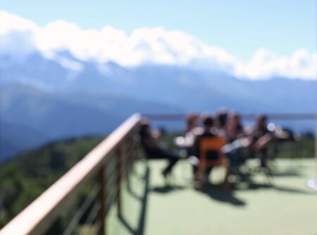 Terrace with people and mountain views. Blur background.の写真素材