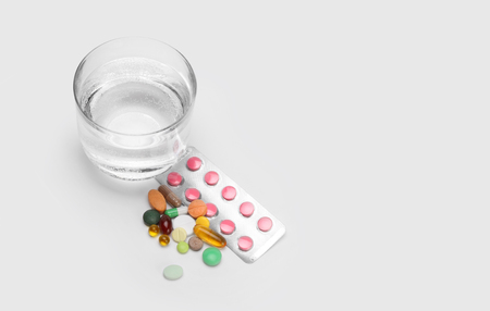 glass of water and vitamins, pills and tabletsの写真素材