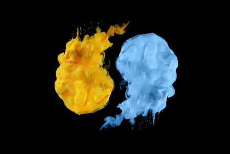 Acrylic colors in water. Ink blot. Abstract black background.  