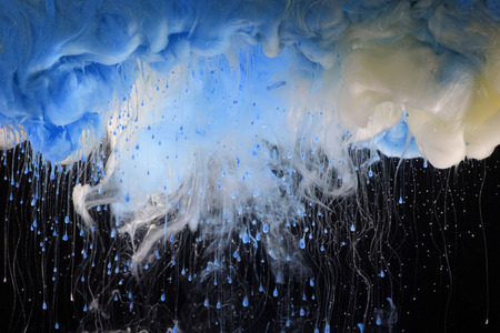 Acrylic colors in water. Ink blot. Abstract black background.