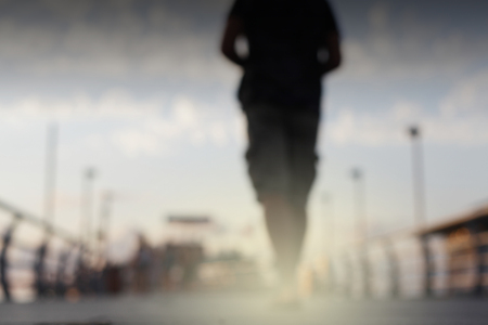 Abstract street city light blur blinking background. Soft focus. Man silhouette.
