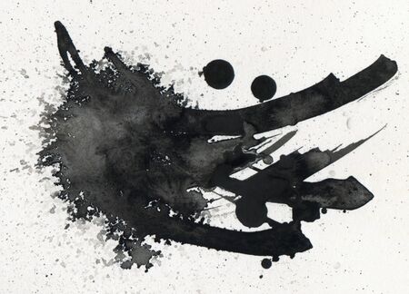 Black ink blot on paper texture bakground.の写真素材