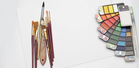 Watercolor paint rainbow palette with brush on white texture paper. Flat lay.  Top view..の写真素材