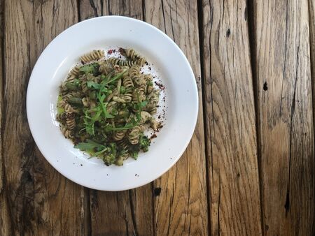 Nutty Fusilli (Italian pasta) with chicken, vegetables, Arugula and pesto sauce.  Gluten free dish. Flat lay.  Top view.の写真素材