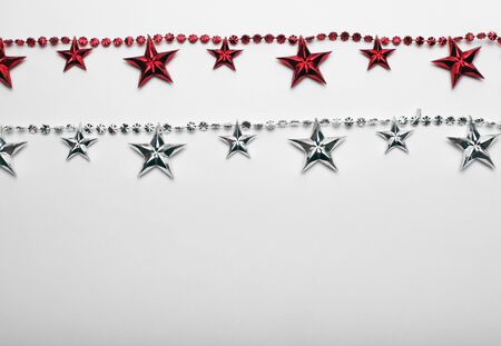 Red and silver star garland on white backgroun. Flat lay.  Top view.の写真素材