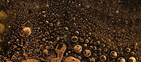 Macro black and gold Abstract bubble drop texture background. Acrylic color in water and oil. Horizontal long banner.の写真素材