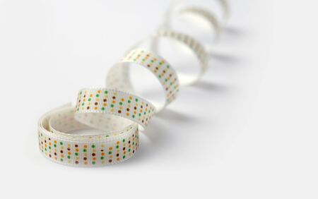 white silk ribbon with color dots on white backgroundの写真素材