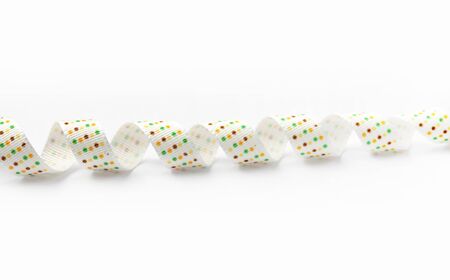 white silk ribbon with color dots on white backgroundの写真素材