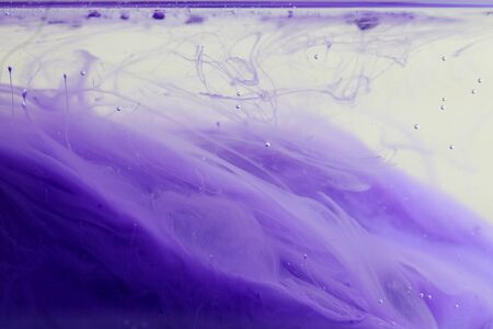 Acrylic colors and ink in water. Abstract background. Violet tone.の写真素材