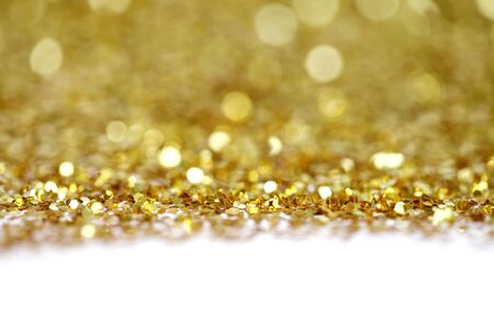 Soft de-focus backgound. Gold (bronze) glitter shine dots confetti. Abstract light blink sparkle.の写真素材