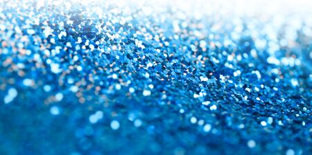 Blue glitter shine dots confetti. Abstract light blur blink sparkle defocus background.の写真素材