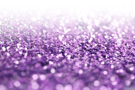 Violet glitter shine dots confetti. Abstract Soft light blur blink sparkle defocus background.の写真素材
