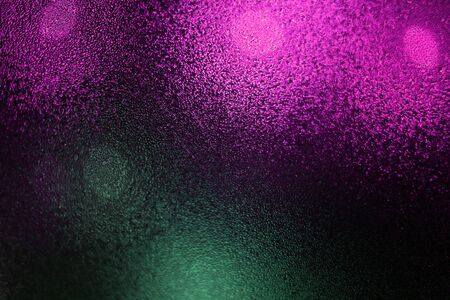 Water drops on wet window glass with city lightsの写真素材