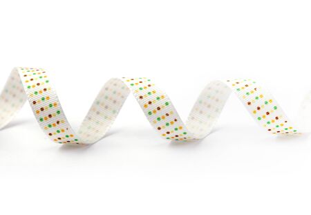 white silk ribbon with color dots on white backgroundの写真素材