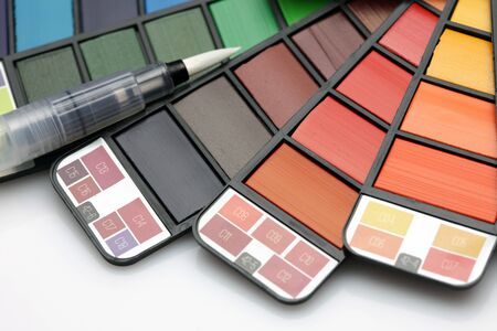 Watercolor paint rainbow palette with brush on white texture paper. の写真素材