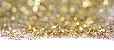 Gold glitter shine dots confetti. Abstract light blur blink sparkle defocus backgound.の写真素材