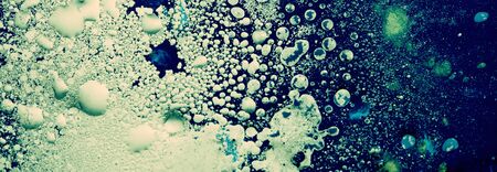 Blue color Abstract bubble drop texture background. Acrylic color in water and oil. Horizontal long banner.の写真素材