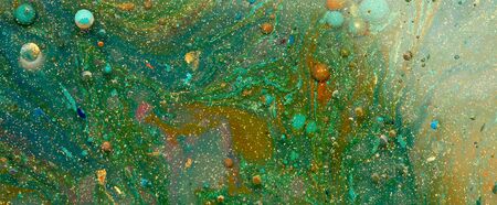 Green color blot painting marble texture. Abstract horizontal background. Acrylic color in water and oil.の写真素材
