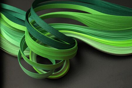 Green color strip wave paper. Abstract texture black background.の写真素材