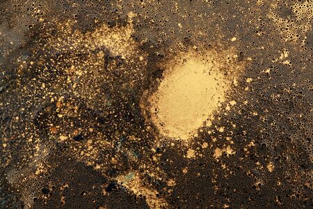 Macro black and gold abstract bubble texture background. Acrylic color in water and oil. の写真素材
