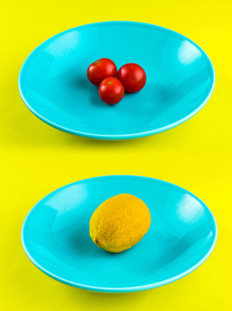 Tomatoes and lemon blue dish yellow の写真素材