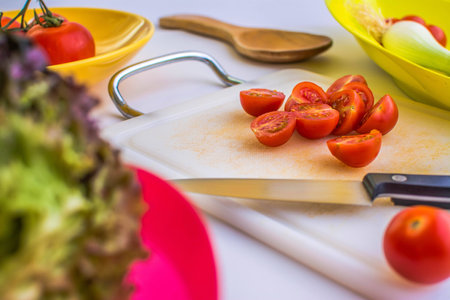 Cut tomatoes with knife kitchenの写真素材