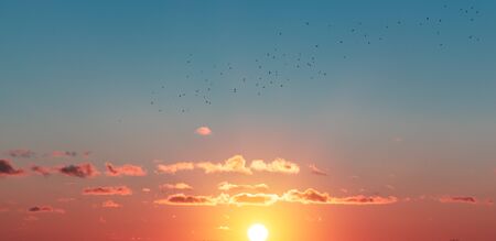 orange clouds in the light of raspberry sunsetの写真素材