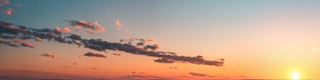 sunset panorama with clouds on a blue sky backgroundの写真素材