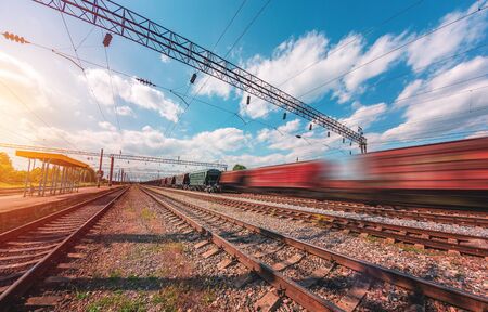 freight, passenger train moves with speed by railの写真素材