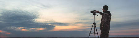 Silhouette of a young who like to travel and photographer, taking pictures of the beautiful moments...