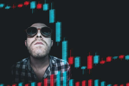 A trader-investor is watching the price movement on the screen with emotions. Analyzes the financial holographic chart of quotes. Comic image of a trader-investor.の写真素材