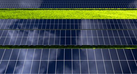 Rows of solar panels in a field on a background of green grass. Ground power plant of alternative...