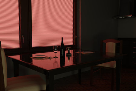 A table set for two with a bottle of wine, glasses, candle and dishes. Warm red light creates a romantic atmosphere of the evening interior.の写真素材