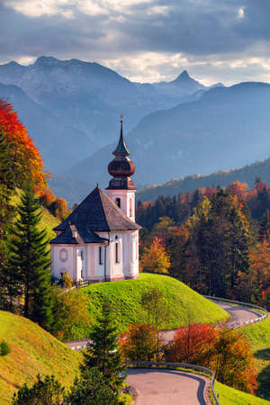 Autumn in Bavarian Alps. Landscape image of the Bavarian Alps with Maria Gern Church and Watzmann mountain during beautiful autumn sunset.の写真素材