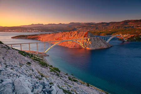 Krk Bridge, Croatia. Image of Krk Bridge which connects the Croatian island of Krk with the mainland at beautiful summer sunset.の写真素材