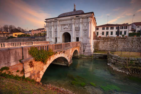 Treviso, Italy. Cityscape image of Treviso, Italy with gate to old city at sunset.の写真素材