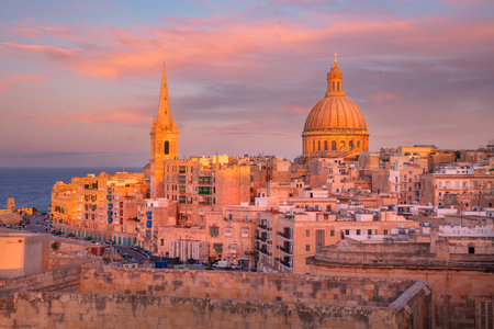Valletta, Malta. Cityscape image of historical old town of Valletta, Malta with Basilica of Our Lady of Mount Carmel at beautiful autumn sunset.の写真素材