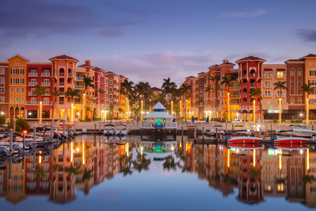Naples, Florida, USA. Cityscape image of Naples, Florida with reflection of the city skyline in the water at beautiful sunrise.の写真素材