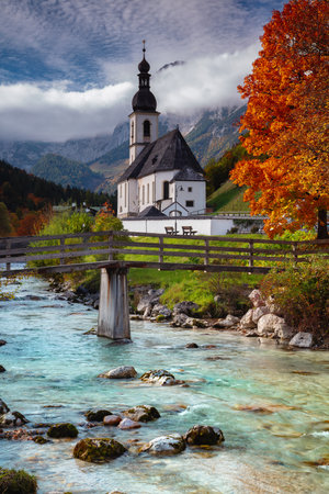 Autumn in Alps. Landscape image of the Bavarian Alps with Parish Church of St. Sebastian located in Ramsau bei Berchtesgaden, Germany during beautiful autumn day.の写真素材