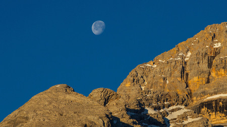 The moon gives way to dawn in the Pragser Dolomitesの写真素材