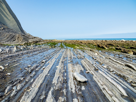 Flysch Coast of Sakoneta, Zumaia, Spain. Flysch is a sequence of sedimentary rock layers that...