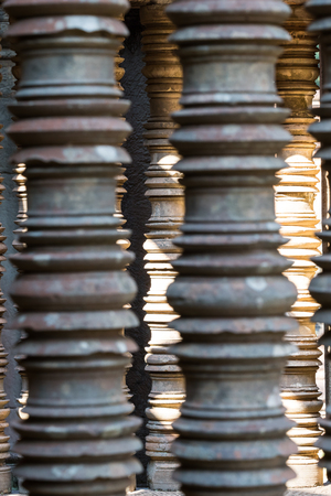 Stone pillar window decor of ancient temple in Angkor Wat complex, Cambodia. Banteay Samre architecture detail. Angkorian pillar window closeup. Ancient stone carving decorの写真素材