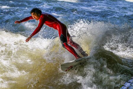 Munich, Germany - July 13, 2019: Surfer in the city river, Munich is famous for people surfing in urban enviroment called Eisbachのeditorial素材