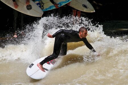 Munich, Germany - July 13, 2019: Surfer in the city river, Munich is famous for people surfing in...