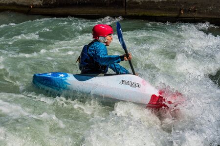 Augsburg, Germany - June 16, 2019: Whitewater kayaking, extreme kayaking. A guy in a kayak sails on...