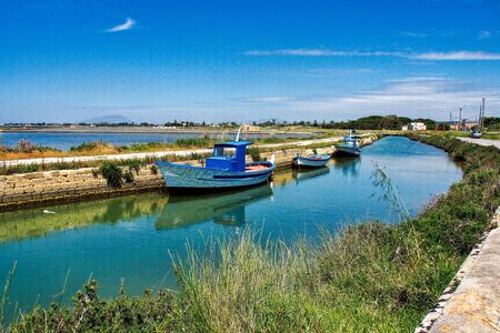 Windmills at the natural reserve of the Saline dello Stagnone near Marsala and Trapani, Sicily in Italyの写真素材