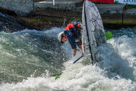 Augsburg, Germany - June 16, 2019: Whitewater kayaking, extreme kayaking. A guy in a kayak sails on the Eiskanal in Augsburg Germanyのeditorial素材