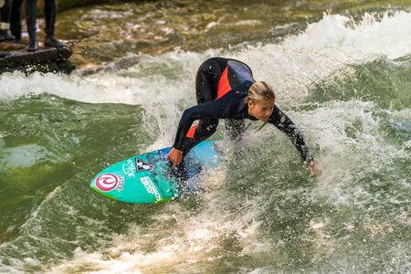 Munich, Germany - July 13, 2019: Surfer in the city river, Munich is famous for people surfing in...