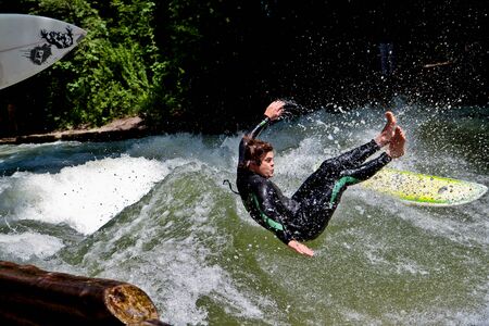 Munich, Germany - July 13, 2019: Surfer in the city river, Munich is famous for people surfing in...